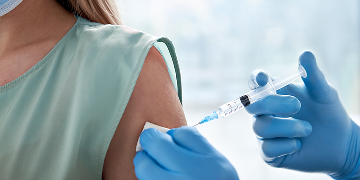 Young woman receiving a vaccination jab Young woman receiving a vaccination jab